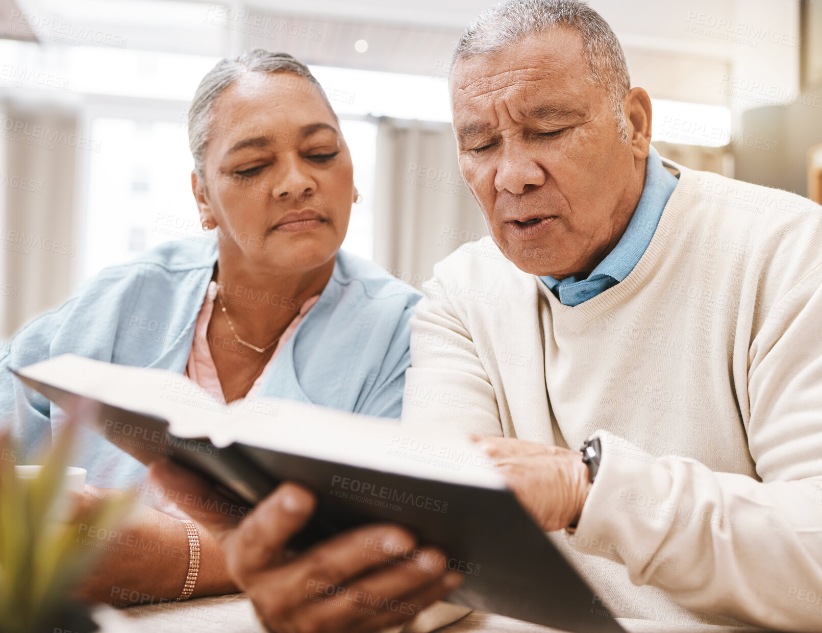 Buy stock photo Bible, praying or old couple reading a book together in a Christian home in retirement with hope or faith. Jesus, religion or belief with a senior man and woman in prayer to god for spiritual bonding
