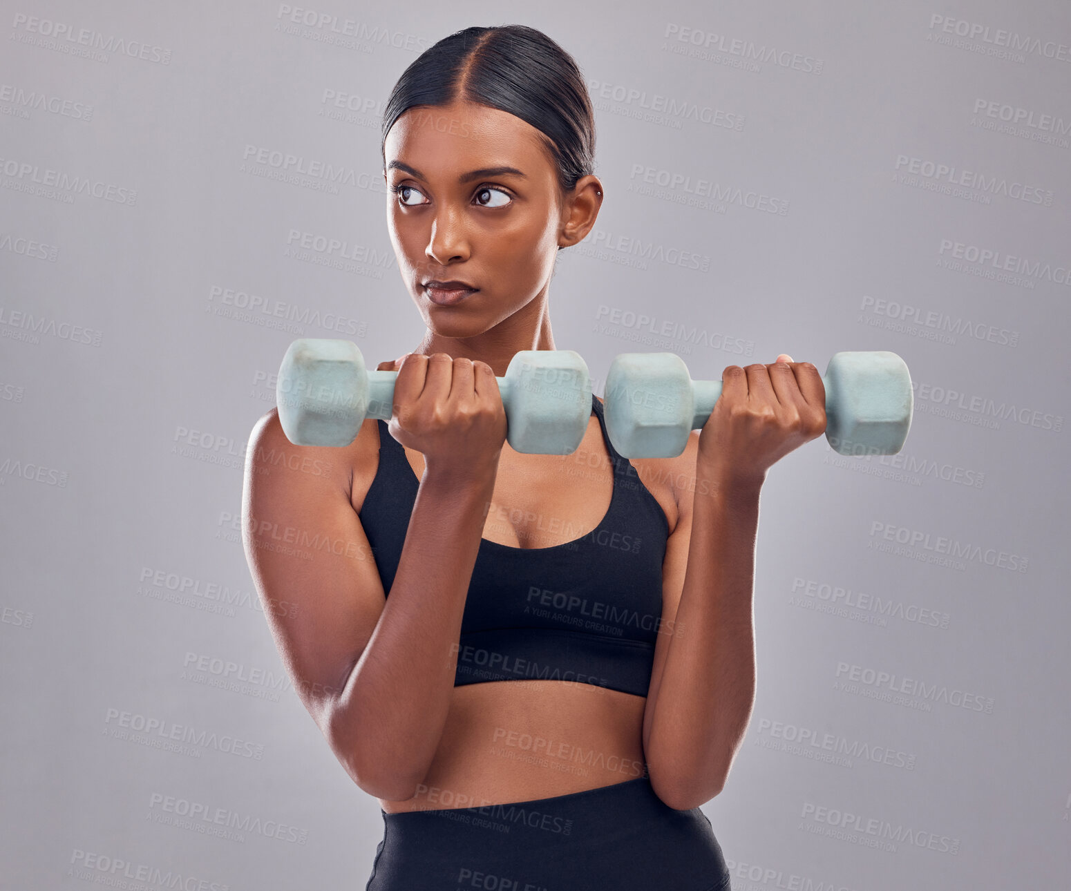 Buy stock photo Woman, focus and dumbbell training in studio for strong body, action or thinking of mindset goals. Indian female, bodybuilder and weights of fitness, power exercise or muscle energy of sports workout