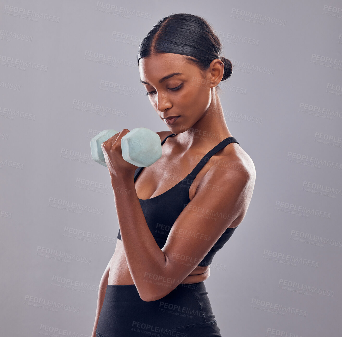 Buy stock photo Black woman, dumbbells training and studio for muscle development, wellness and self care with focus. Gen z bodybuilder girl, exercise and strong healthy body with gym equipment by gray background