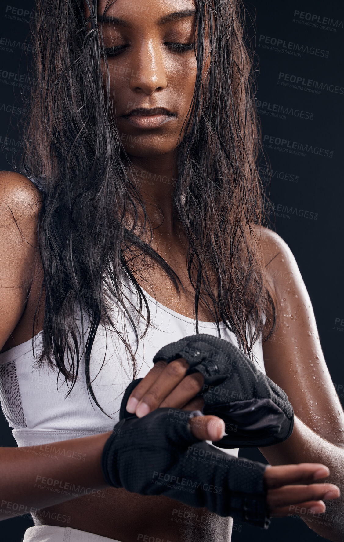 Buy stock photo Boxer, gloves and sweat with a sports woman getting ready in studio on a black background for fitness. Exercise, health and training with a female boxing athlete sweating during a combat workout