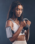 Woman, kettlebell and portrait of exercise in studio for fitness, sports workout or serious mindset. Face of strong female, bodybuilder and weights for training with armband, energy and on background