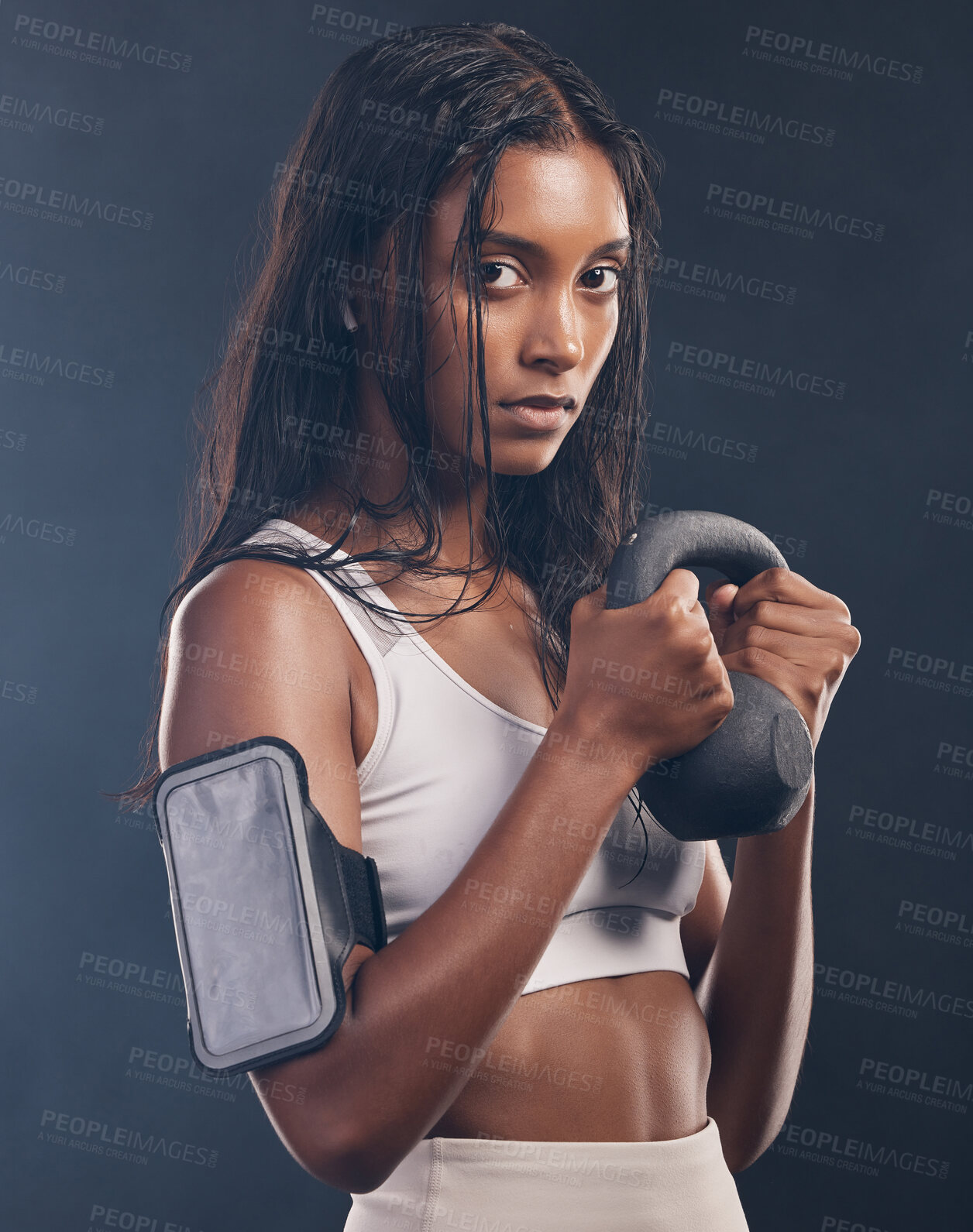 Buy stock photo Woman, kettlebell and portrait of exercise in studio for fitness, sports workout or serious mindset. Face of strong female, bodybuilder and weights for training with armband, energy and on background