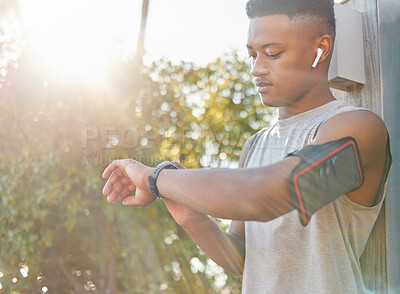 Buy stock photo Fitness, black man and watch checking time or performance for running exercise, workout or training in nature. African American male runner looking at wristwatch for tracking or monitoring cardio