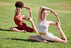 Women, yoga friends and stretching on grass for wellness, strong legs and body goals in morning sunshine. Woman team, fitness and exercise on lawn field with support, focus and mindfulness in summer