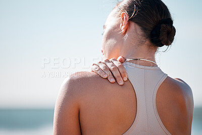 Buy stock photo Tired, shoulder pain and fitness with woman at beach with mockup for yoga, workout and training. Burnout, injury and physical therapy with girl in city park for health, sport and pilates goals