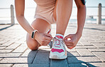 Closeup, fitness and woman tie shoes, training and exercise for wellness, health and performance. Zoom, female athlete and lady with tying shoes, ready for marathon and run for cardio and energy 