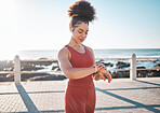 Fitness, black woman and watch checking by beach for time, performance or tracking exercise in the outdoors. Happy African American female runner smiling looking at wristwatch for monitoring workout