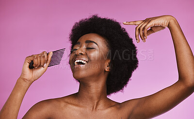 Buy stock photo Singing black woman, hair or afro comb on background in fun grooming routine, natural skincare play or growth texture karaoke. Beauty, happy or hairstyle brush microphone on isolated pink performance