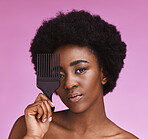 Portrait, black woman with comb and hair care with grooming, morning routine or studio background. Face, African American female or lady with cosmetics equipment, salon treatment or shine on backdrop