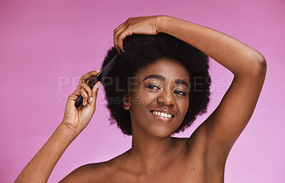 Buy stock photo Black woman, hairstyle and afro brush on beauty studio background in grooming routine, texture maintenance or wellness. Happy model, comb and natural hair growth with skincare makeup on isolated pink