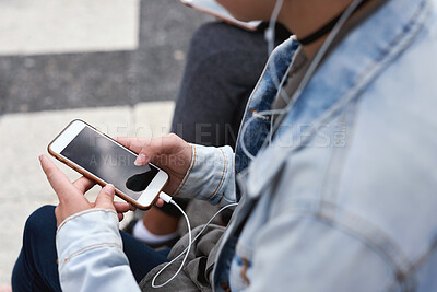 Buy stock photo Woman, smartphone screen and earphones in city for social media, radio technology and iot internet. Female hands in street listening to music with cellphone mockup, connection and mobile podcast app