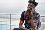 African american man using smartphone talking on mobile phone call conversation by the beach