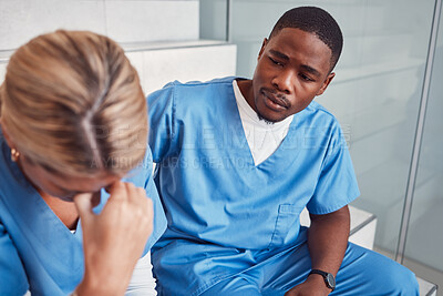 Buy stock photo Doctors, nurses or healthcare team with stress and depression talking about empathy. Black man support crying woman in hospital with mental health, depression and anxiety for crisis fail or mistake
