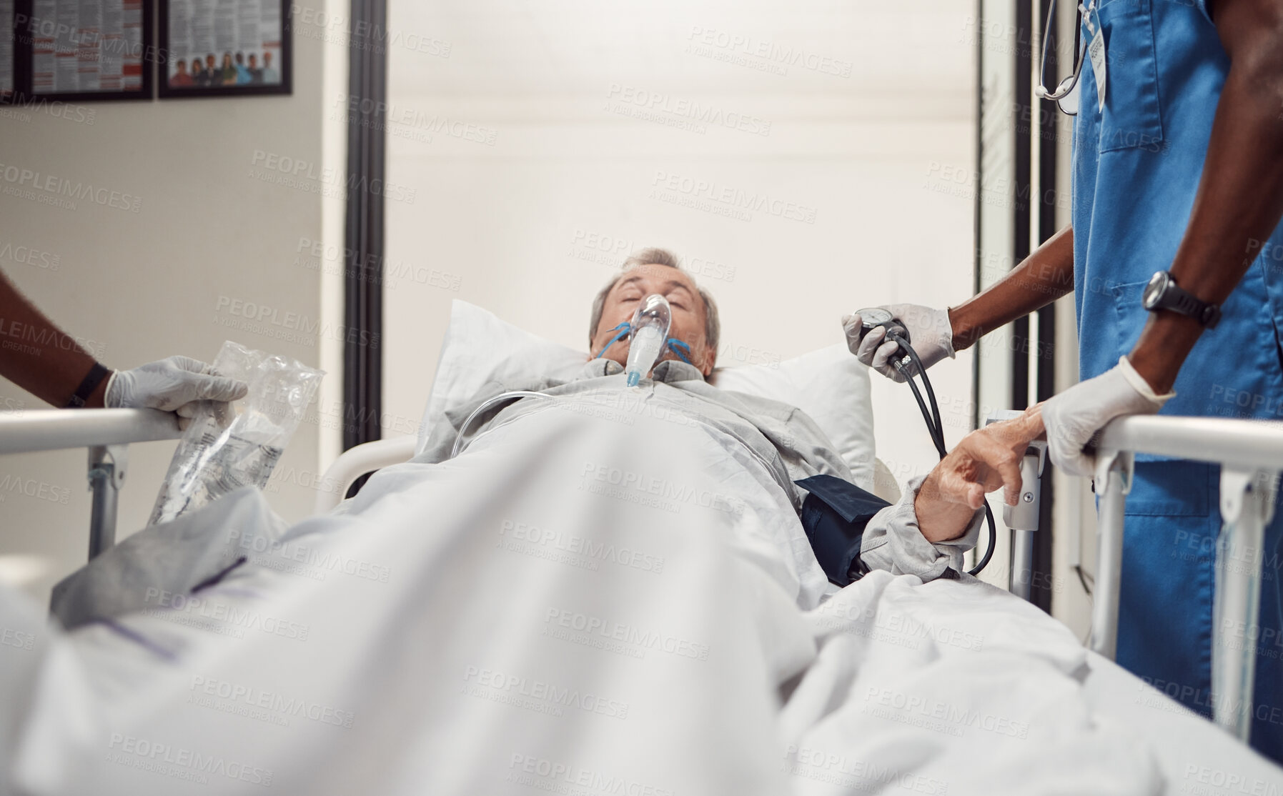 Buy stock photo Hospital, senior patient and doctors for emergency on a bed with oxygen mask for healthcare. Sick old man with health problem and medical team er or surgery in theater for life insurance and help