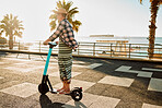 Electric scooter, retirement and woman riding on sidewalk at tropical island beach resort for happy vacation. City, street and eco friendly transport, fun for grandma on escooter on holiday in Hawaii