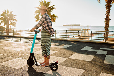 Buy stock photo Electric scooter, retirement and woman riding on sidewalk at tropical island beach resort for happy vacation. City, street and eco friendly transport, fun for grandma on escooter on holiday in Hawaii