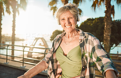 Buy stock photo Happy, music and smile with portrait of old woman at beach for streaming, freedom or summer. Internet, technology and headphones with senior lady listening to online radio for podcast, audio or media