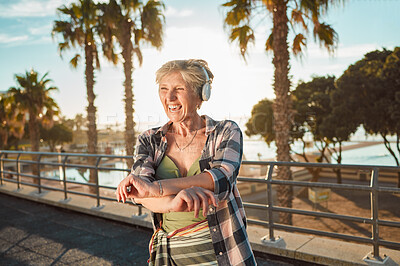 Buy stock photo Happy old woman, headphones and music on holiday at tropical island resort with smile and palm trees. Summer, happiness and funky grandma streaming 5g radio service on retirement vacation in Hawaii.