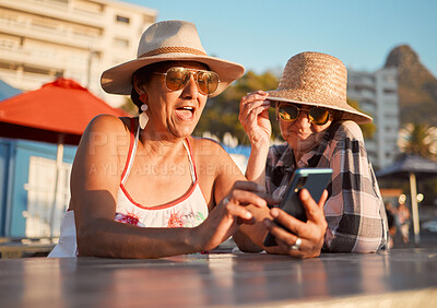Buy stock photo Friends, senior women and phone for internet, search or browse social media, break or summer, retirement or holiday. Elderly people and ladies bond for profile picture or meme at outdoor restaurant