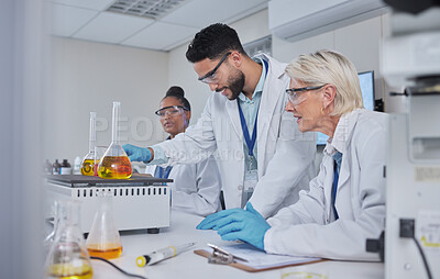 Buy stock photo Chemistry, science and team with liquid in lab for medical research, study and vaccine development. Biotechnology, pharmaceutical and group of scientists with sample for analysis, test and experiment