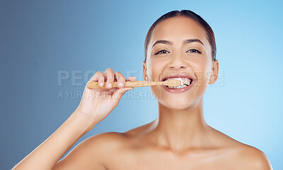 Buy stock photo Bamboo toothbrush, toothpaste and portrait of woman for dental wellness, healthy cleaning or model cosmetics. Happy female teeth, eco wooden brush and mouth for smile, face and studio blue background