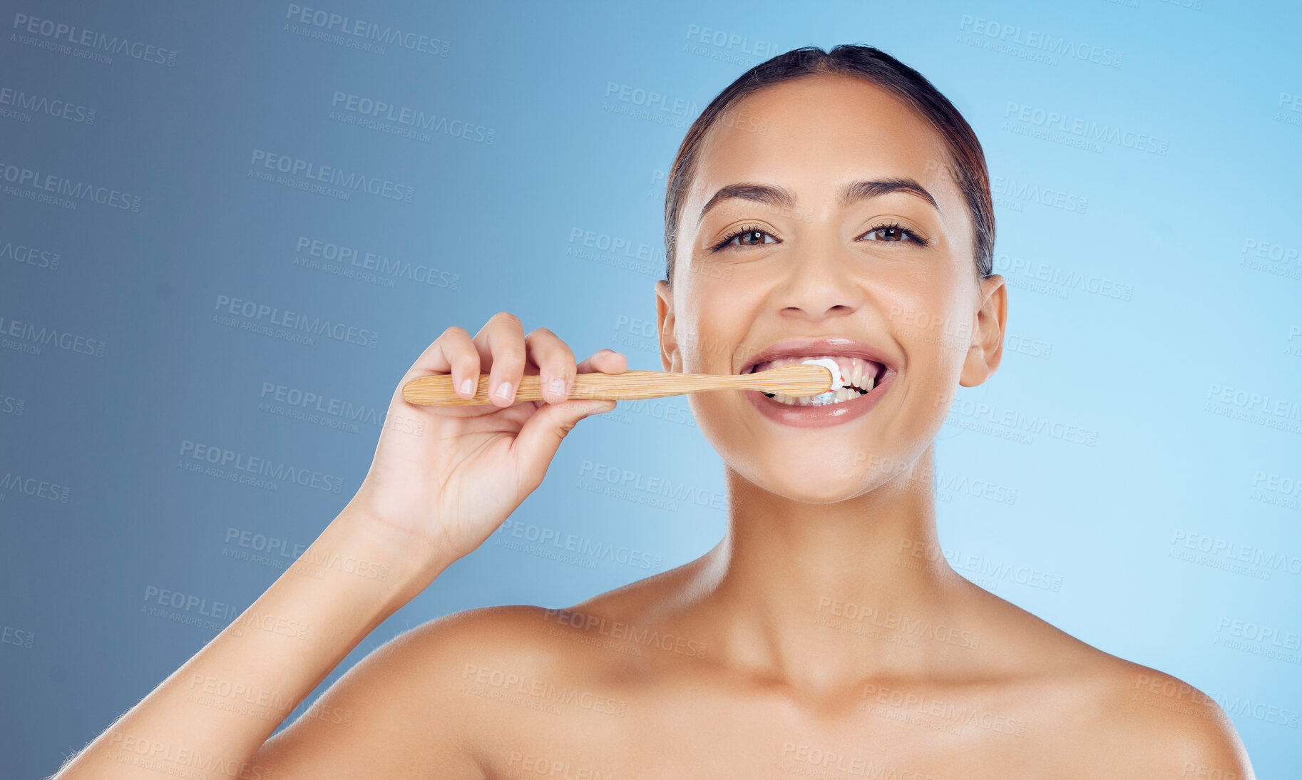 Buy stock photo Bamboo toothbrush, toothpaste and portrait of woman for dental wellness, healthy cleaning or model cosmetics. Happy female teeth, eco wooden brush and mouth for smile, face and studio blue background