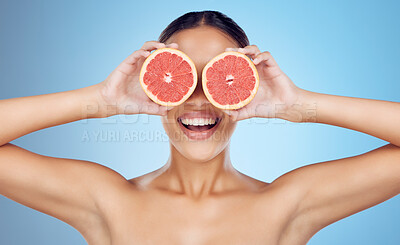 Buy stock photo Grapefruit, woman and cover eyes for beauty on studio background, wellness benefits and smile. Skincare model, diet and citrus fruits for natural detox, healthy nutrition and happy face for vitamin c