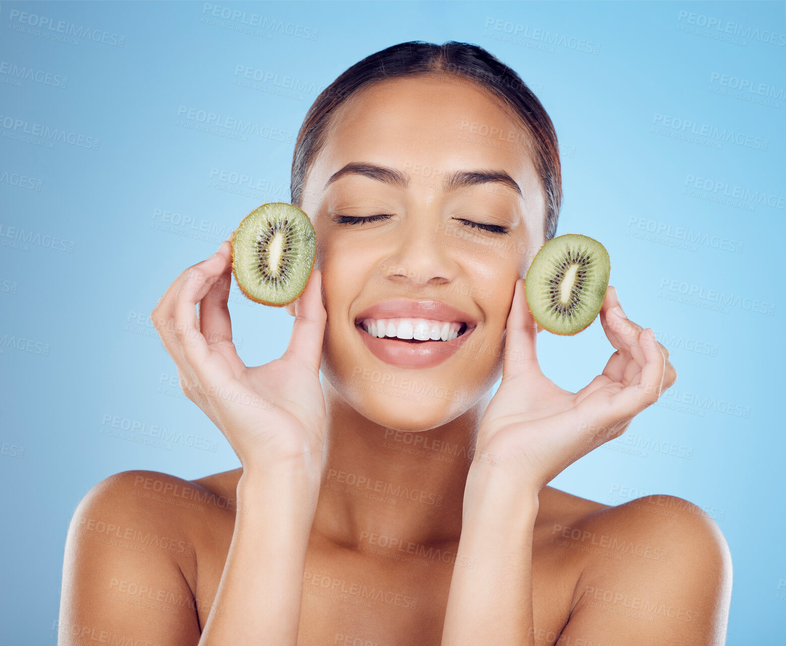 Buy stock photo Kiwi, woman and beauty for skincare cosmetics, natural food product and blue studio background. Happy model, organic fruit and vitamin c nutrition for vegan diet, detox wellness and face aesthetic 