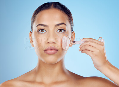 Buy stock photo Woman, portrait and face roller for beauty, facial product and aesthetic skincare in studio. Young model, crystal stone treatment and wellness for natural cosmetics, rose quartz dermatology and salon