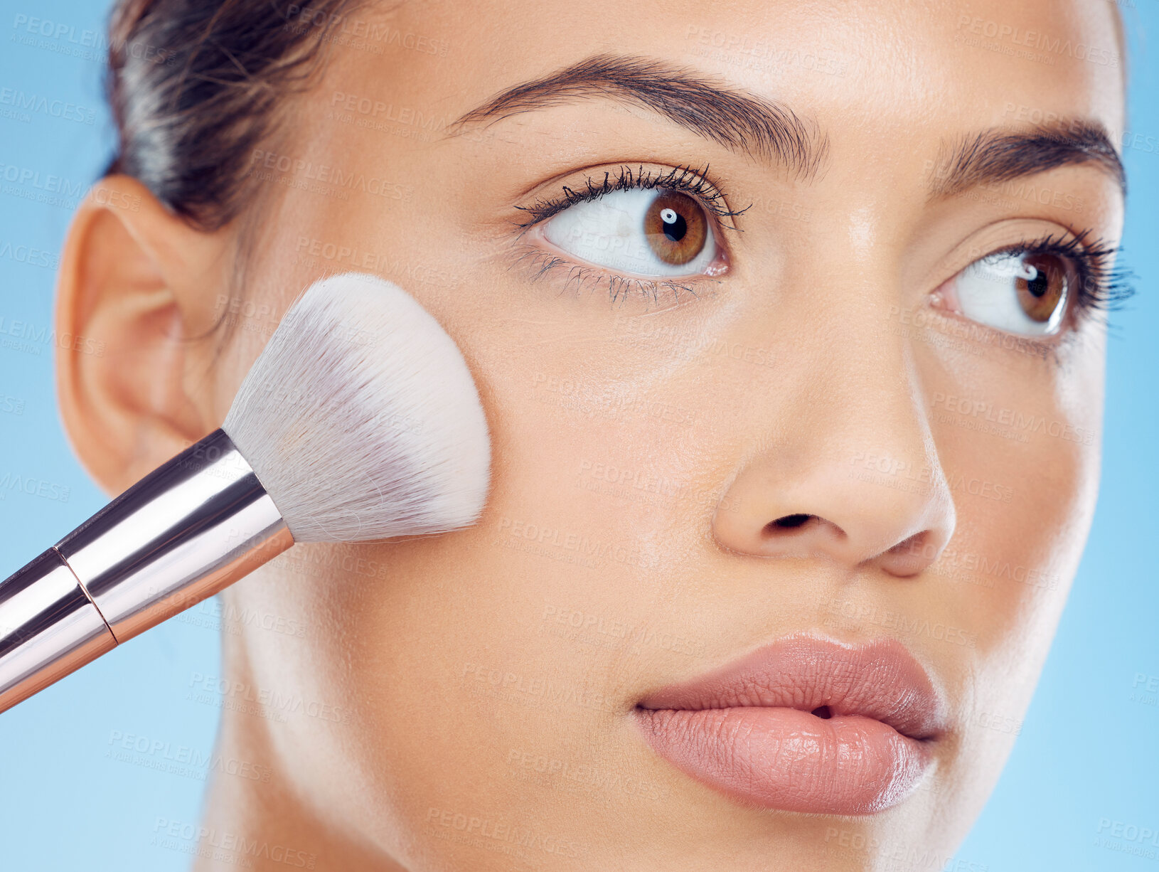 Buy stock photo Woman, face and makeup brush for skincare, cosmetics and dermatology in studio. Application tools, cosmetic product and skincare aesthetic for beauty, self care and skin glow with blue background 