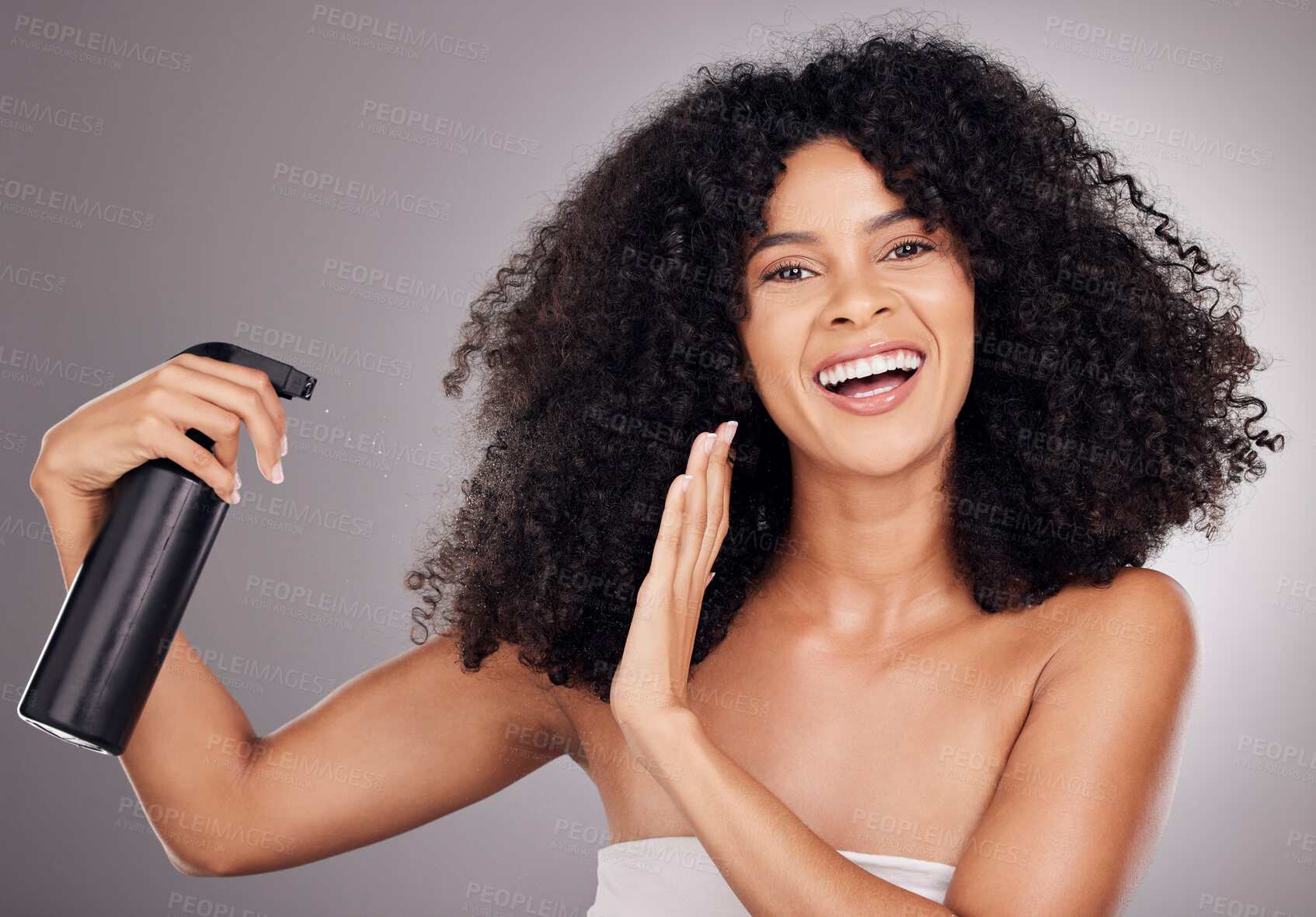 Buy stock photo Portrait of black woman spray on hair for wellness, growth and natural shine on gray background. Beauty, salon and happy face of girl smile with hairspray, cosmetic products and keratin treatment