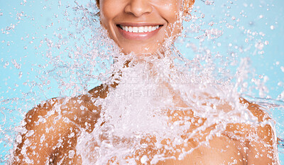 Buy stock photo Water, splash and black woman cleaning her body for beauty, skincare and self care isolated in studio blue background. Portrait, model and young female washing skin for hygiene, aqua and hydration