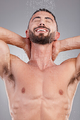 Buy stock photo Shower, beauty and happy man isolated on studio background with water drops for face and body cleaning. Strong, beauty and fitness model or person washing for hygiene, skincare and dermatology