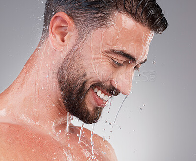 Buy stock photo Shower, grooming and smile, man isolated on grey background for skincare, health and wellness mockup in studio. Water, face and happiness, male model cleaning and washing skin and facial hair profile