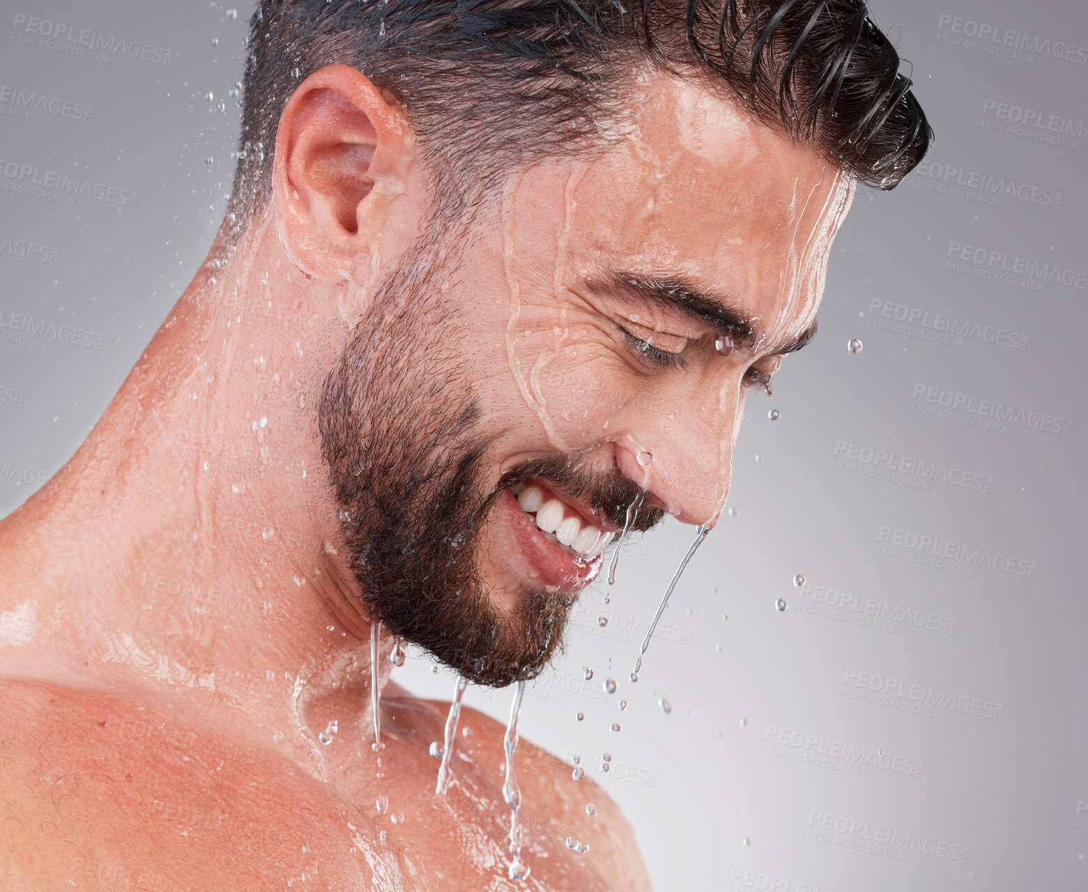 Buy stock photo Shower, grooming and smile, man isolated on grey background for skincare, health and wellness mockup in studio. Water, face and happiness, male model cleaning and washing skin and facial hair profile