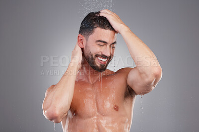 Buy stock photo Shower, keratin and cleaning hair with a man in studio on a gray background for hygiene or grooming. Water, haircare and washing with a handsome young male in the bathroom for shampoo treatment