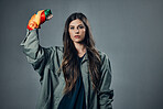 Woman, protest and rainbow fist for gay, LGBTQ or human rights against gray studio background. Portrait of female activist standing ready in fighting for equality, empowerment or sexuality on mockup