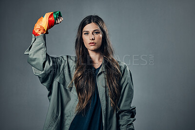 Buy stock photo Woman, protest and rainbow fist for gay, LGBTQ or human rights against gray studio background. Portrait of female activist standing ready in fighting for equality, empowerment or sexuality on mockup