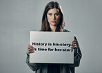 Protest, portrait of woman activist and poster in studio, serious face isolated on grey background. Feminism, mockup and feminist protesting in support of human rights, freedom and equality for women