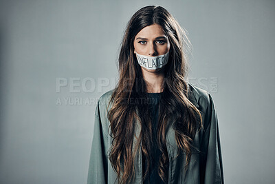 Buy stock photo Woman, protest and tape on mouth for inflation, economic change or financial crisis against gray studio background. Portrait of female activist with message to end government greed or taxes on mockup