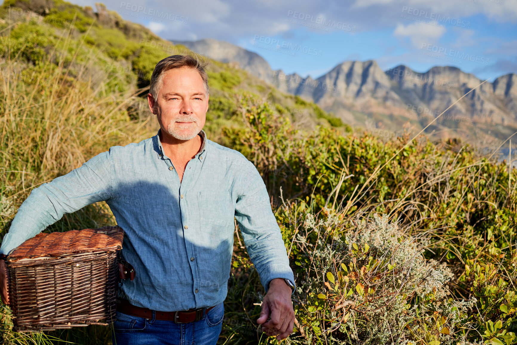 Buy stock photo Picnic, summer and a man in the mountain, walking outdoor in nature for adventure, freedom or recreation. Spring, travel and environment with a male taking a walk in the wilderness alone for hiking