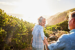 Love, holding hands and nature, senior couple walking with picnic blanket for romance and valentines day. Green mountain path, old man and woman on walk or hike for romantic valentine date at sunset.