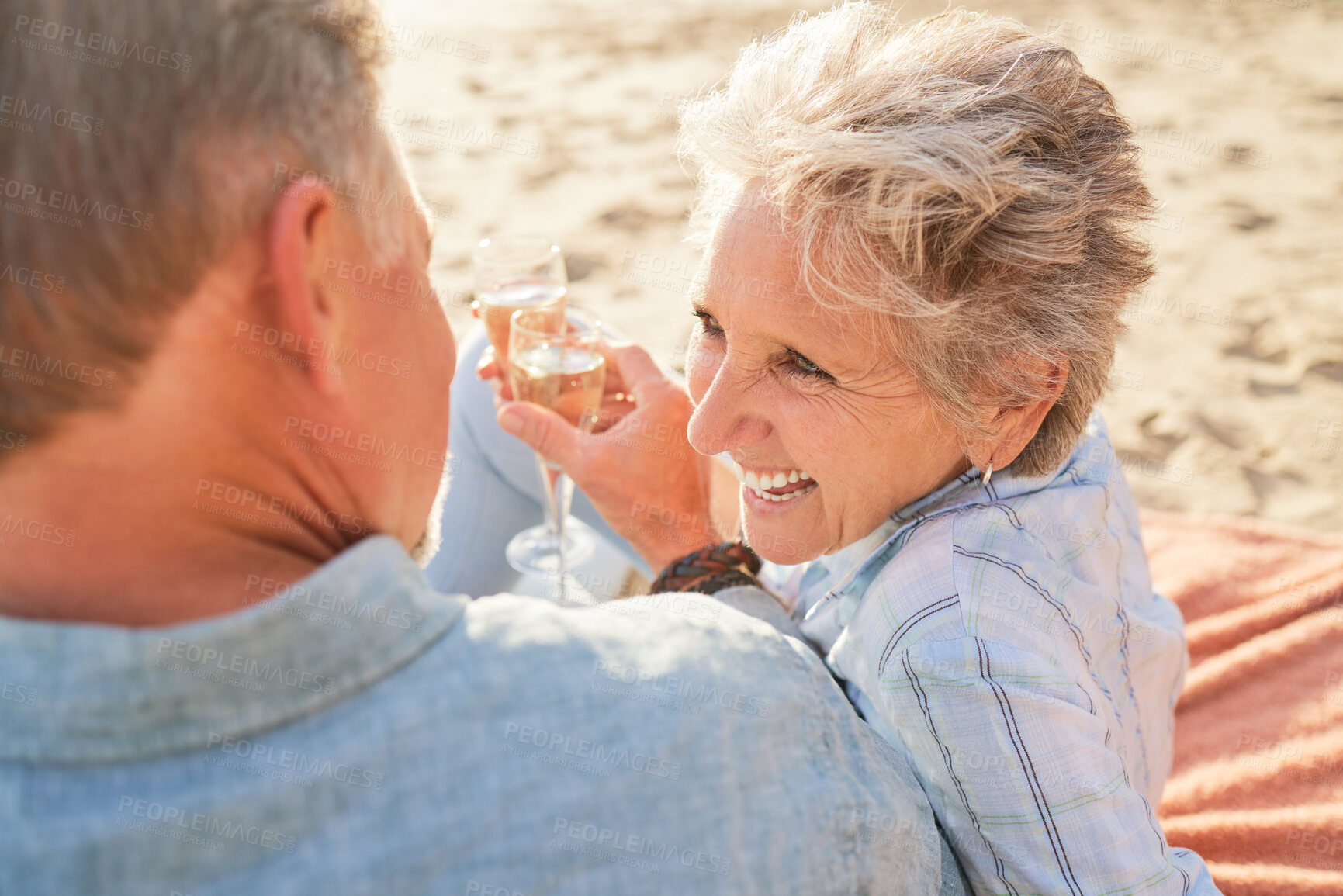 Buy stock photo Champagne, senior beach couple laughing and love with mature care and support of marriage. Toast, wine and sea picnic of a old man and woman together on holiday in summer loving the sunshine outdoor