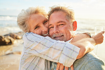 Buy stock photo Senior couple, beach portrait and hug together in summer for conversation, memory and anniversary celebration. Elderly man, old woman and smile for care, wine and outdoor for sunshine, waves or love
