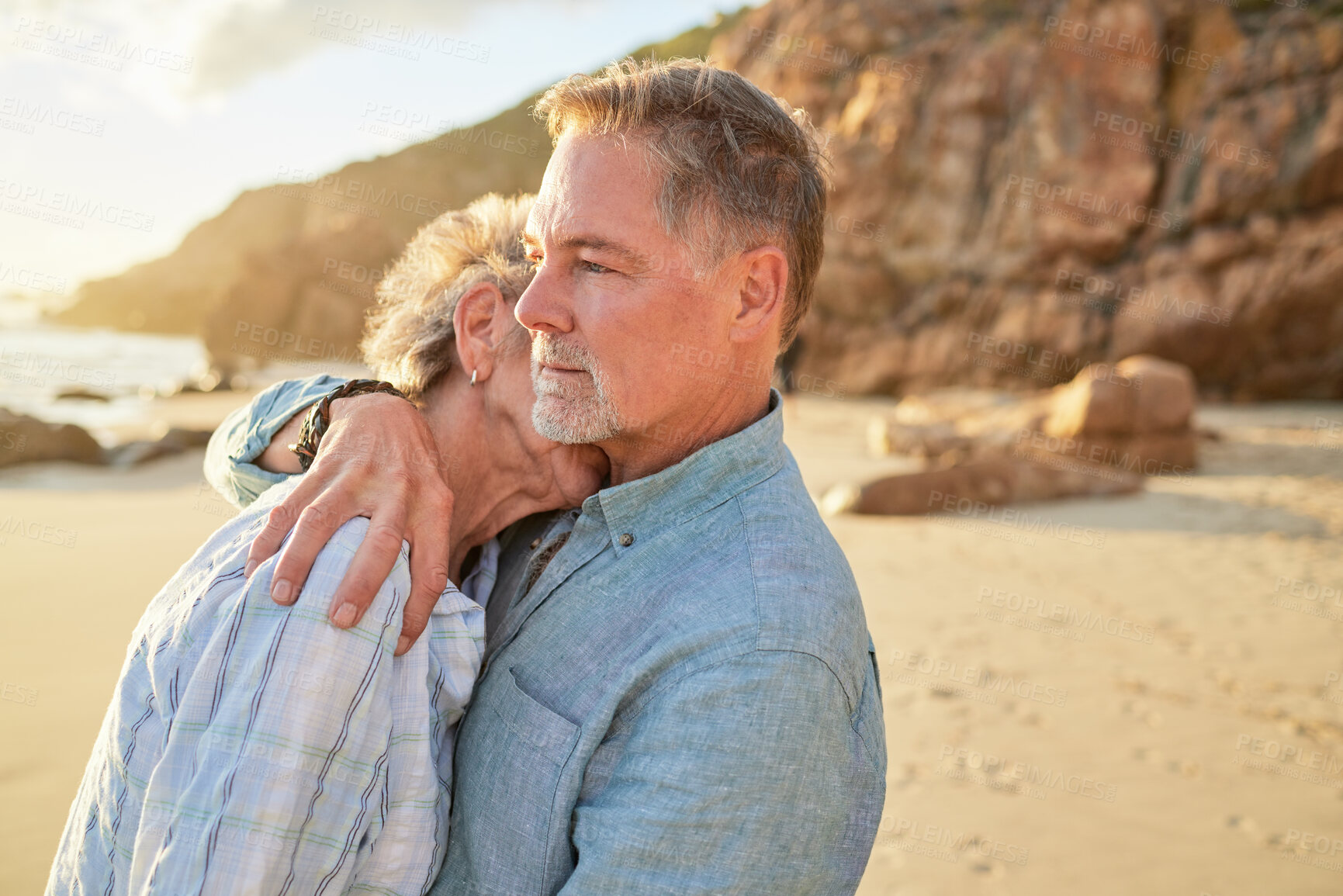 Buy stock photo Beach, senior couple and hug of mature people with love and marriage by the ocean. Retirement, summer holiday and sea vacation of a man and woman together feeling love and support in nature on sand