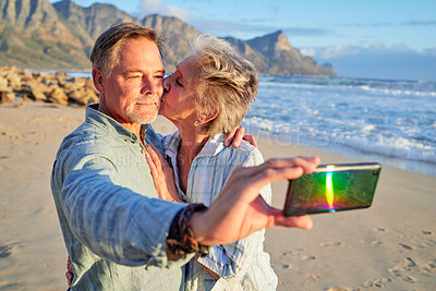 Buy stock photo Selfie, kiss and senior couple at the beach for a vacation memory in retirement in Argentina. Affection, love and elderly man and woman taking a photo at the ocean during a date on valentines day