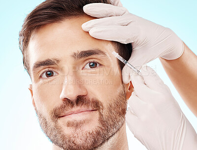 Portrait, man and needle for cosmetics, dermatology and beauty on blue studio background. Face, male and gentleman with skincare, injection and plastic surgery with botox, gloves and facial change