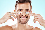 Eye beauty, man and treatment portait witb smile and patches for eyes in a isolated studio. Skincare, spa wellness and facial for model face with cosmetics, dermatology and detox with collagen mask