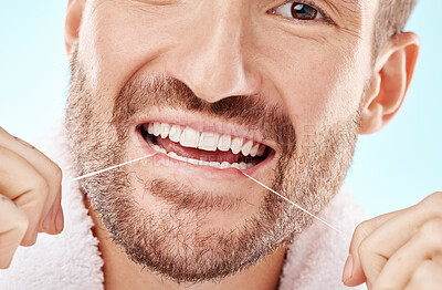 Dental care, health and man flossing teeth in studio for oral wellness or tooth grooming. Dentistry, healthy and closeup of male model doing fresh, clean and natural mouth routine by white background