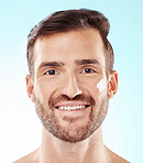 Face portrait, skincare and man with cream in studio isolated on a blue background. Beauty, dermatology and happy male model with creme cosmetics, lotion and facial moisturizer for  healthy skin.